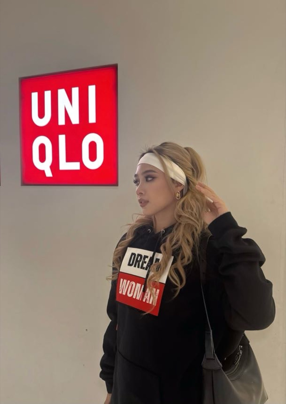 Model in the Dream Woman hoodie outside the UNIQLO storefront in Bangkok