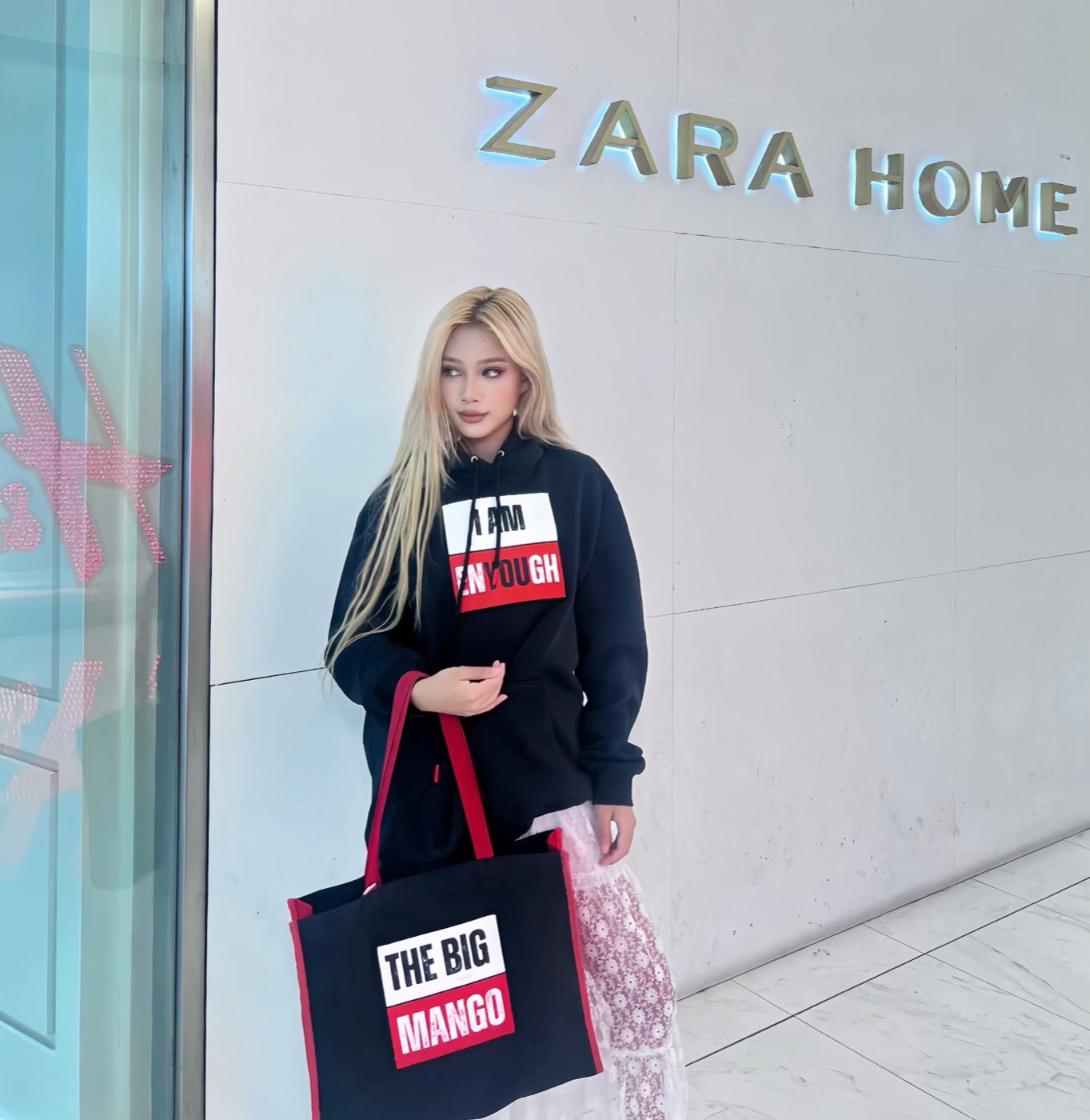 Model in the I Am Enyough hoodie outside the Zara Home storefront in Bangkok