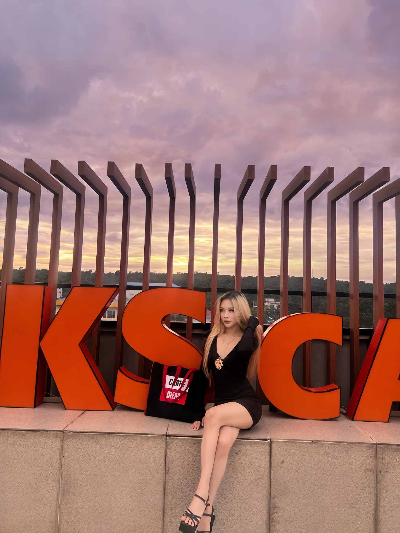 Model at golden hour on a Bangkok rooftop with the Carpe Diem Signal Tote